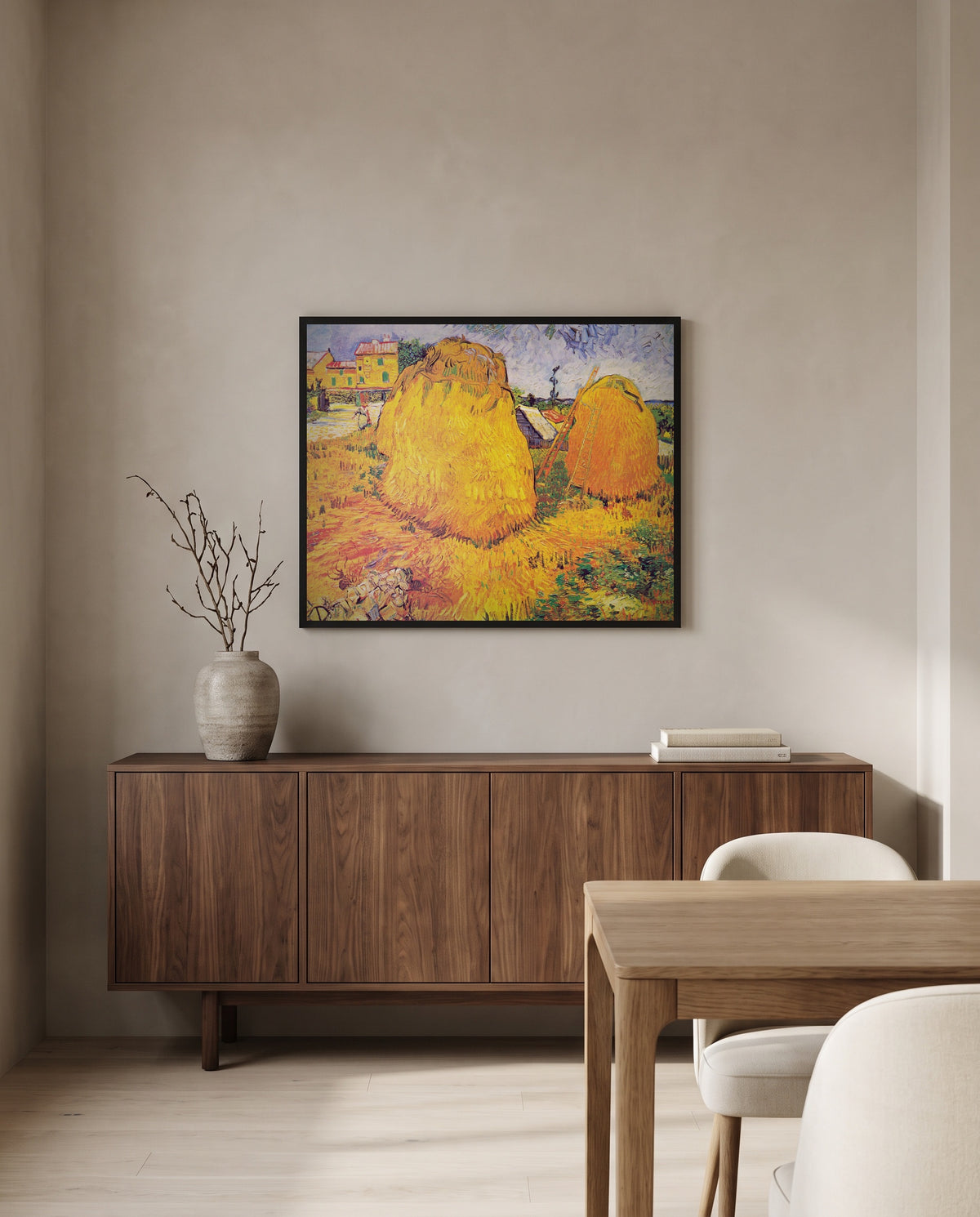 Haystacks in Provence by Vincent van Gogh in a black frame above a walnut sideboard in a dining room