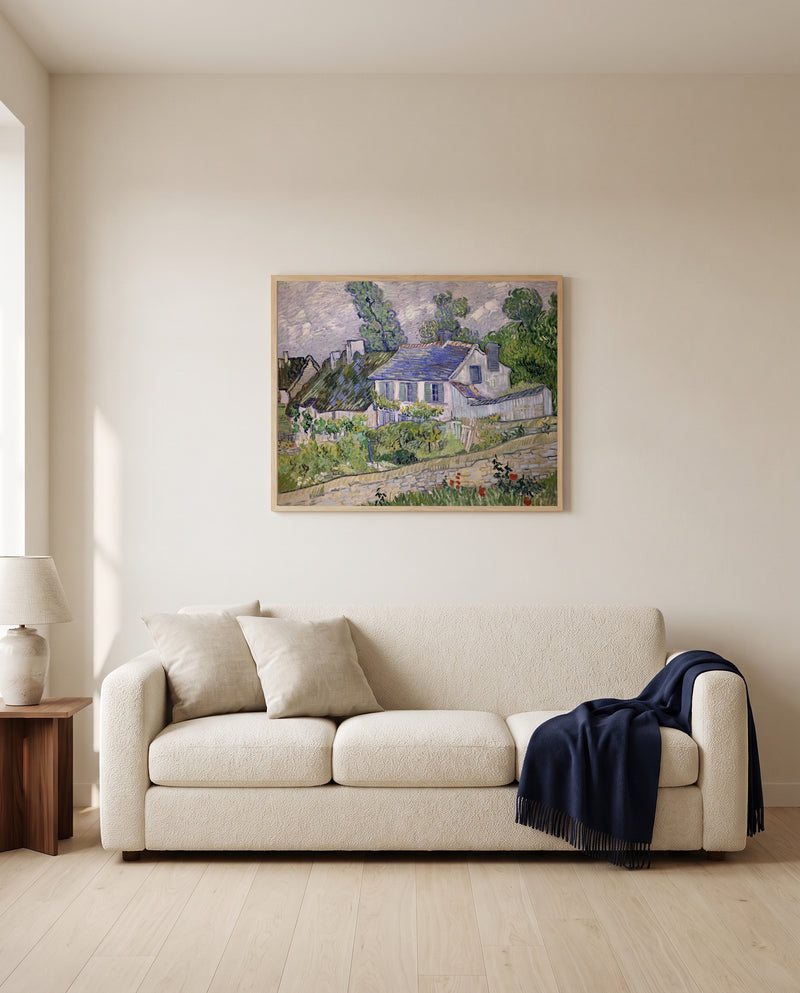 Houses at Auvers by Vincent van Gogh framed in natural oak above a cream sofa in a warm living room
