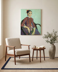 La Mousmé by Vincent van Gogh as a stretched canvas above a linen lounge chair in a reading corner