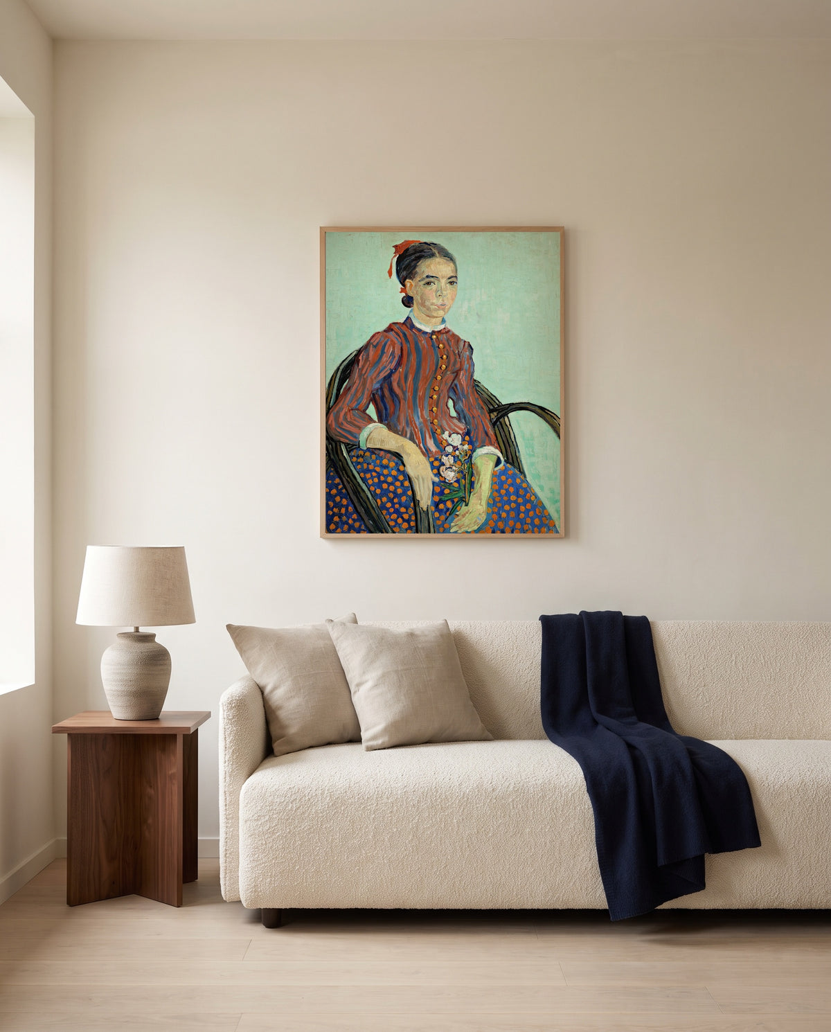 La Mousmé by Vincent van Gogh framed in natural oak above a cream sofa in a warm living room