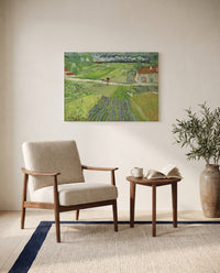 Carriage and Train by Vincent van Gogh as a stretched canvas above a linen lounge chair in a reading corner