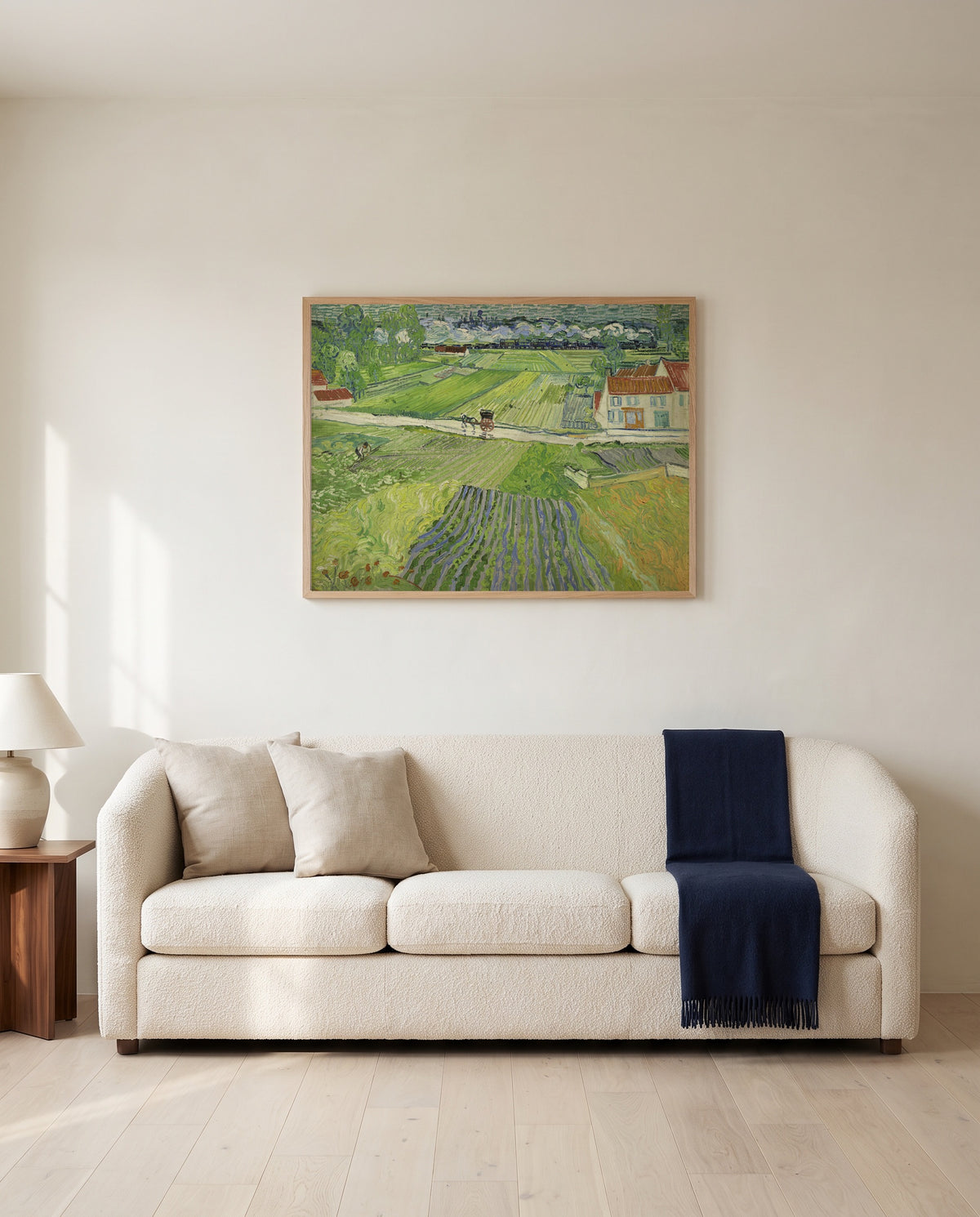 Carriage and Train by Vincent van Gogh framed in natural oak above a cream sofa in a warm living room