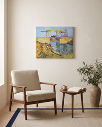 The Langlois Bridge by Vincent van Gogh as a stretched canvas above a linen lounge chair in a reading corner