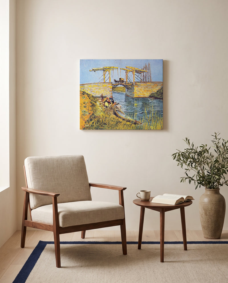 The Langlois Bridge by Vincent van Gogh as a stretched canvas above a linen lounge chair in a reading corner