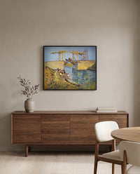 The Langlois Bridge by Vincent van Gogh in a black frame above a walnut sideboard in a dining room