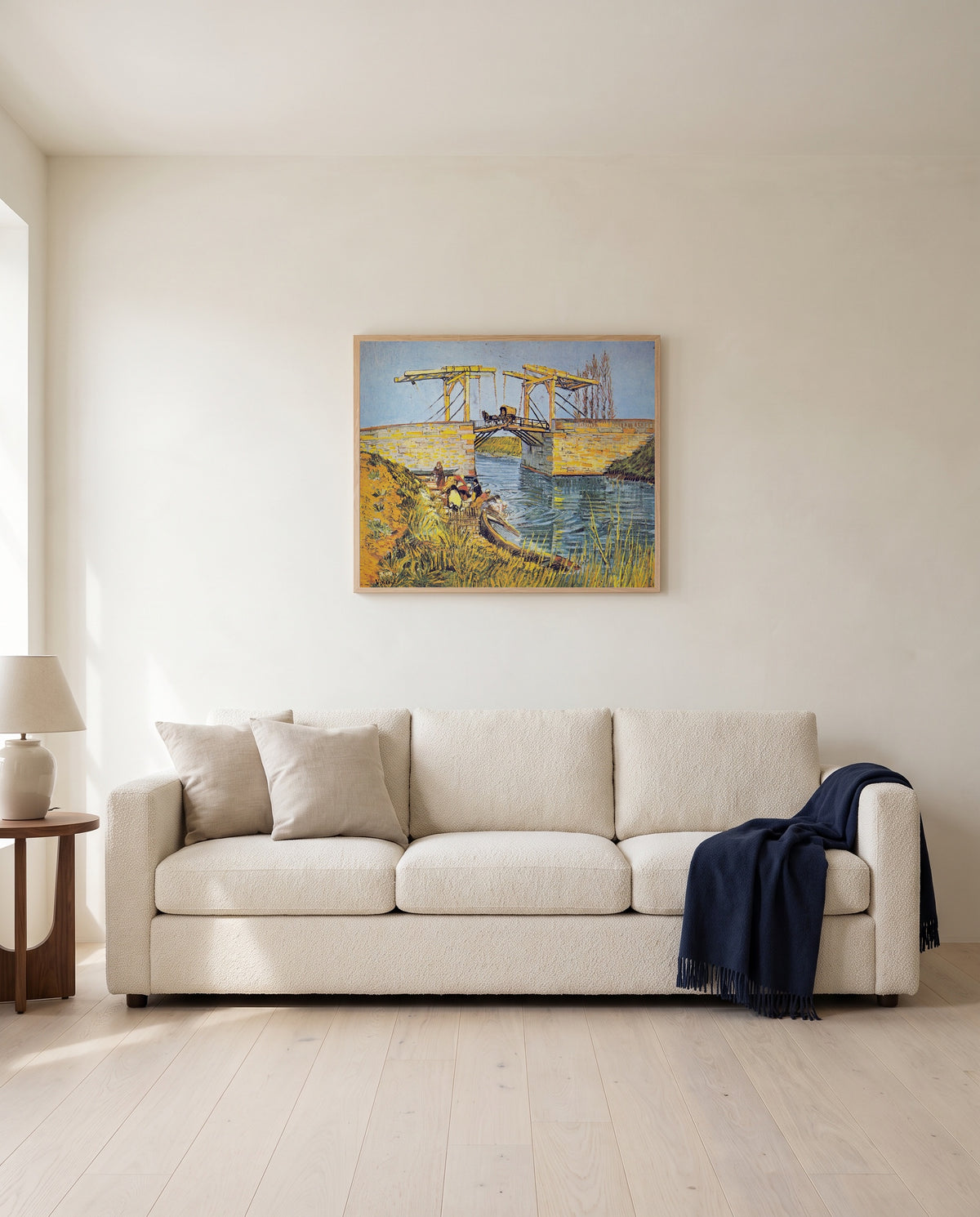 The Langlois Bridge by Vincent van Gogh framed in natural oak above a cream sofa in a warm living room