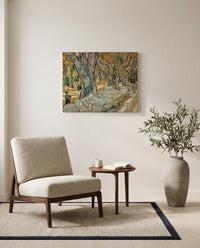 The Large Plane Trees by Vincent van Gogh as a stretched canvas above a linen lounge chair in a reading corner