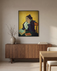 L’Arlésienne by Vincent van Gogh in a black frame above a walnut sideboard in a dining room