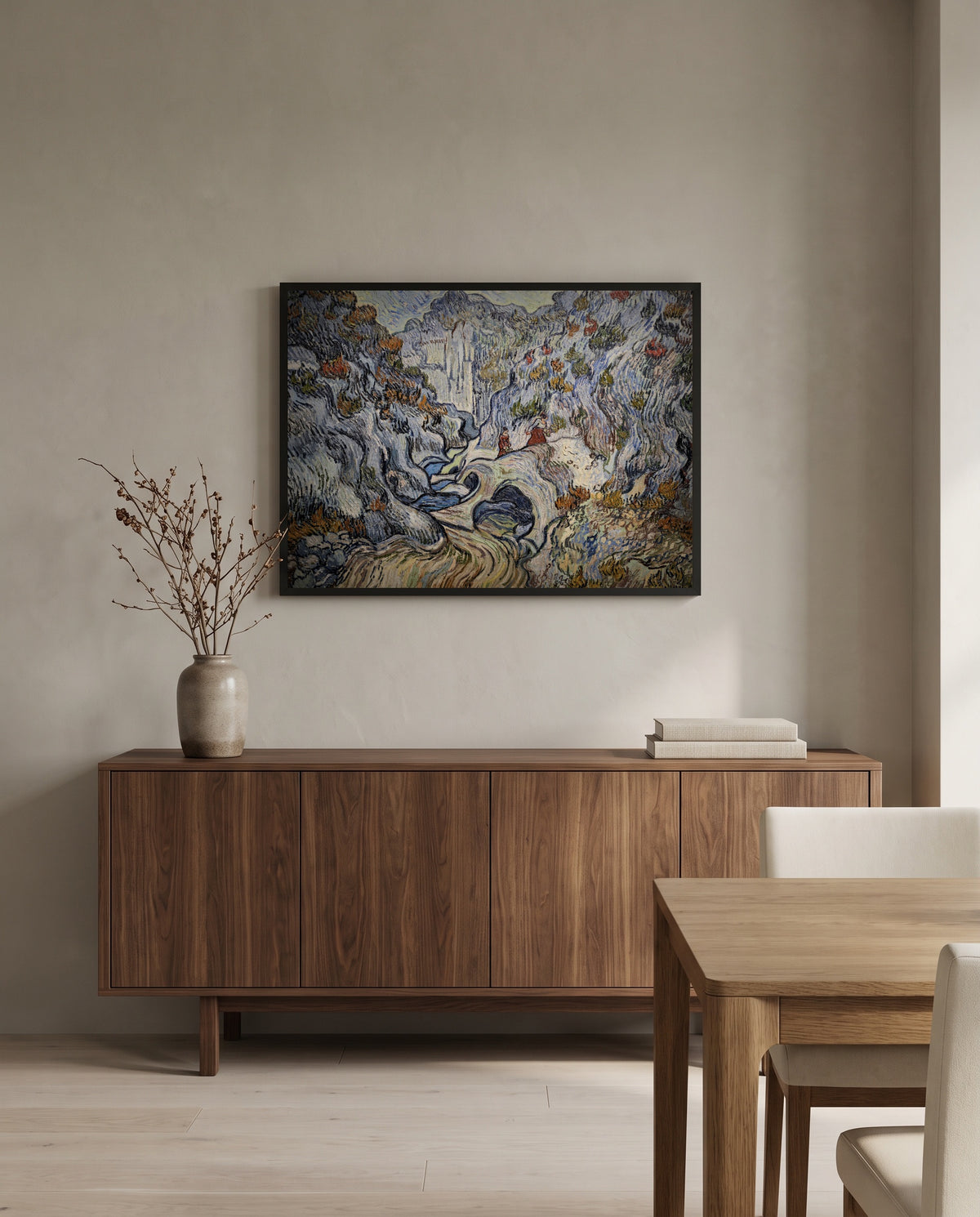 Les Peiroulets Ravine by Vincent van Gogh in a black frame above a walnut sideboard in a dining room