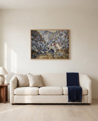 Les Peiroulets Ravine by Vincent van Gogh framed in natural oak above a cream sofa in a warm living room