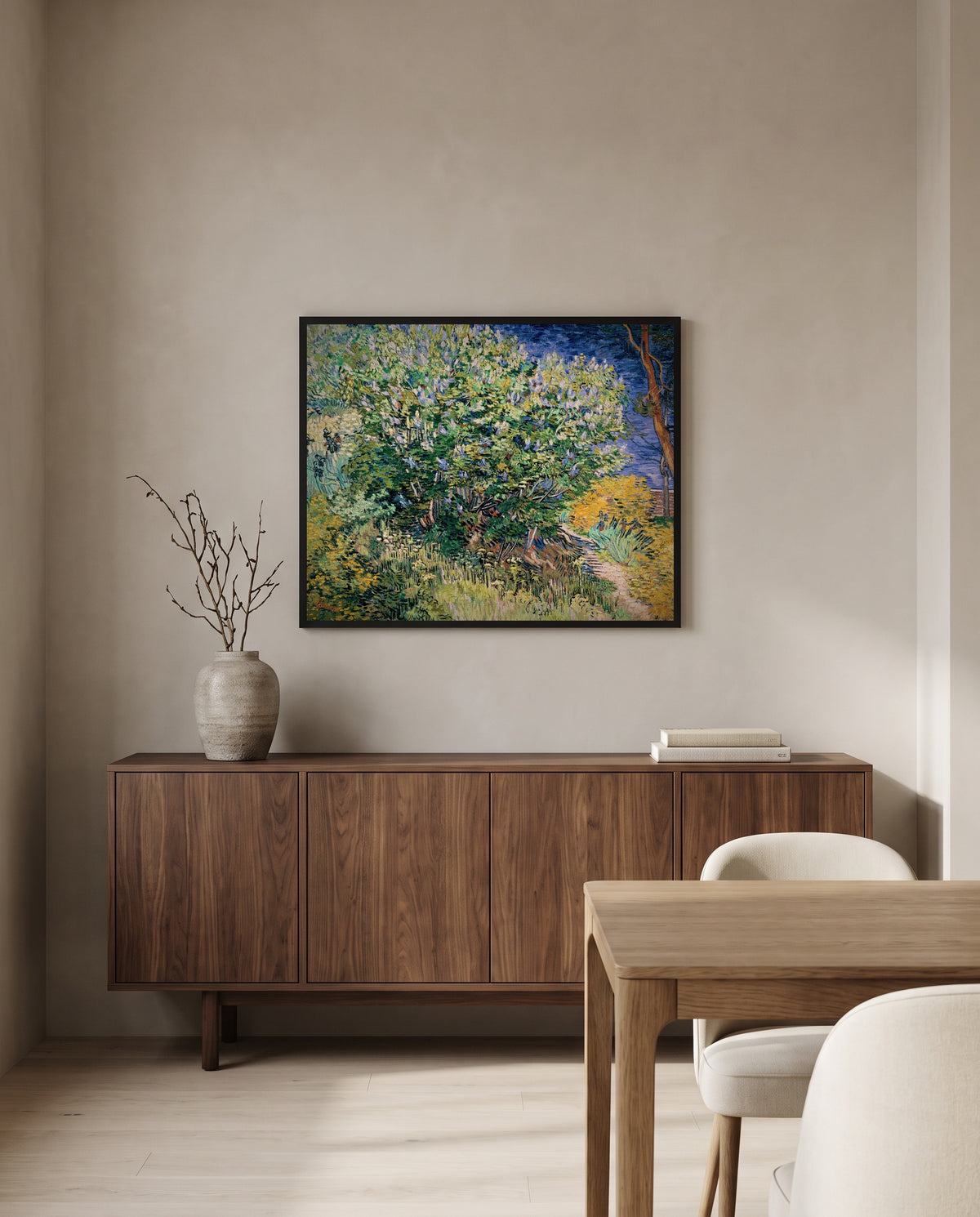 Lilac Bush by Vincent van Gogh in a black frame above a walnut sideboard in a dining room