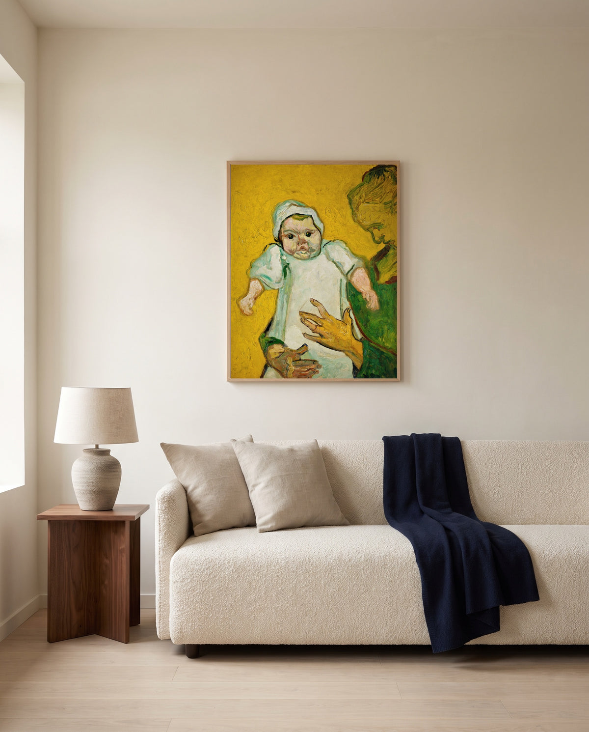 Madame Roulin and Her Baby by Vincent van Gogh framed in natural oak above a cream sofa in a warm living room