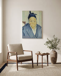 An Old Woman of Arles by Vincent van Gogh as a stretched canvas above a linen lounge chair in a reading corner