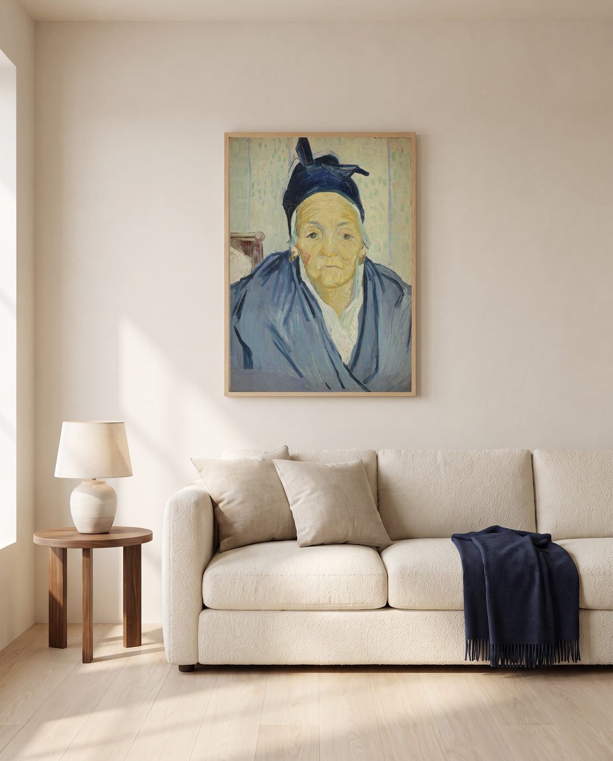 An Old Woman of Arles by Vincent van Gogh framed in natural oak above a cream sofa in a warm living room