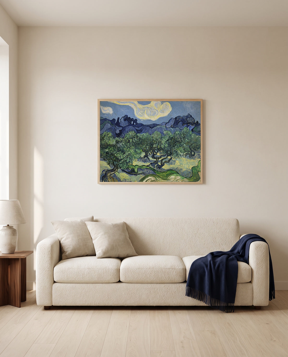 The Olive Trees by Vincent van Gogh framed in natural oak above a cream sofa in a warm living room
