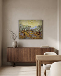 Olive Trees with Yellow Sky by Vincent van Gogh in a black frame above a walnut sideboard in a dining room