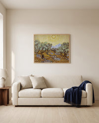 Olive Trees with Yellow Sky by Vincent van Gogh framed in natural oak above a cream sofa in a warm living room