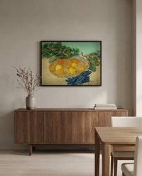 Oranges and Lemons with Blue Gloves by Vincent van Gogh in a black frame above a walnut sideboard in a dining room