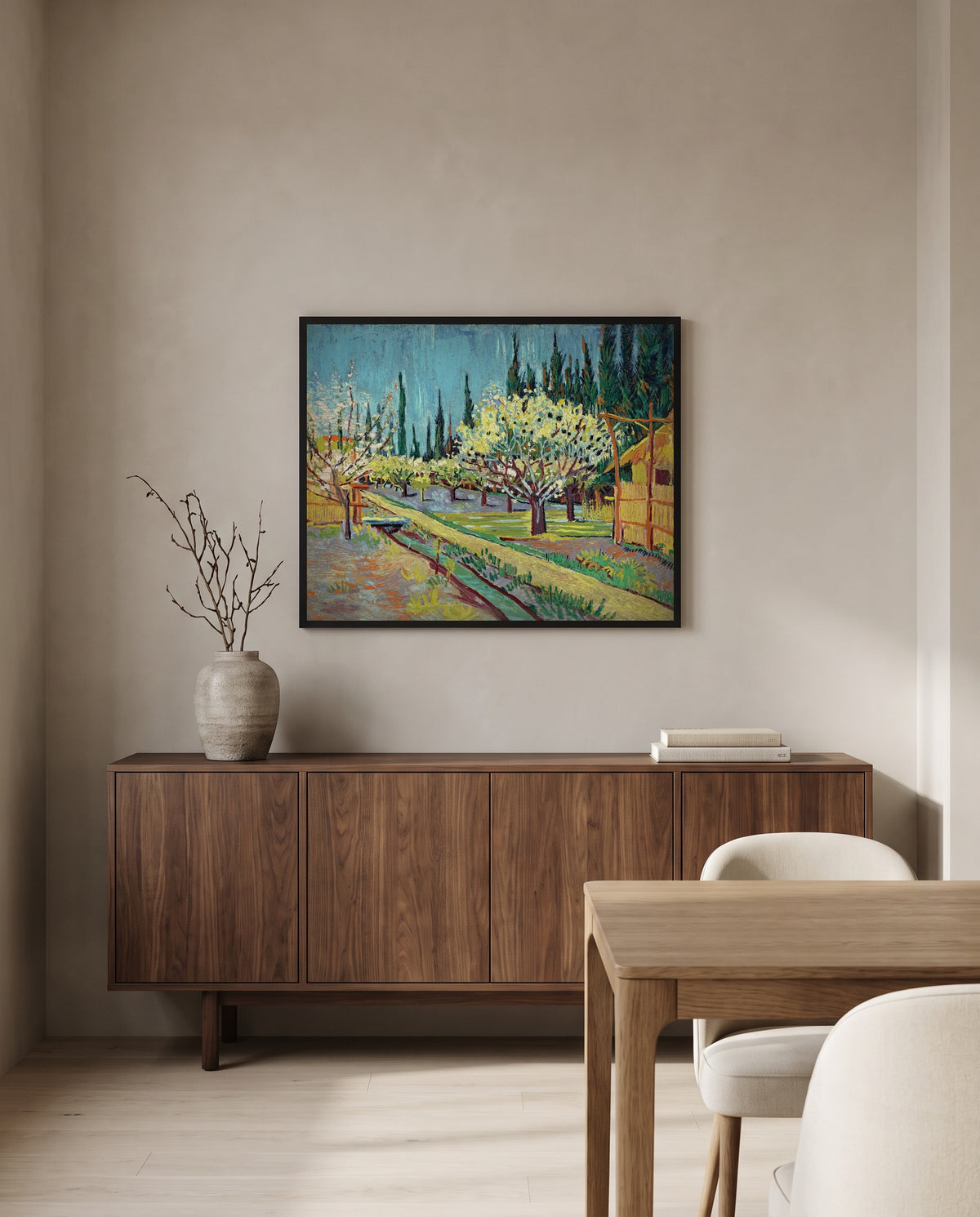 Orchard Bordered by Cypresses by Vincent van Gogh in a black frame above a walnut sideboard in a dining room