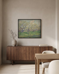 Orchard in Blossom, 1889 by Vincent van Gogh in a black frame above a walnut sideboard in a dining room
