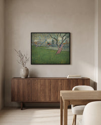Orchards in Blossom, Arles by Vincent van Gogh in a black frame above a walnut sideboard in a dining room