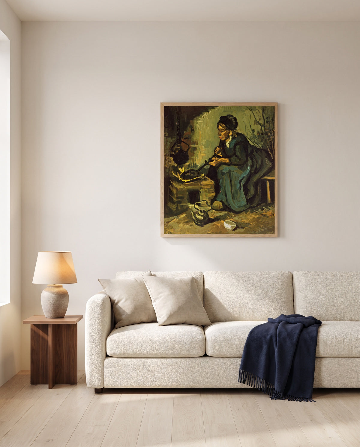 Peasant Woman Cooking by Vincent van Gogh framed in natural oak above a cream sofa in a warm living room