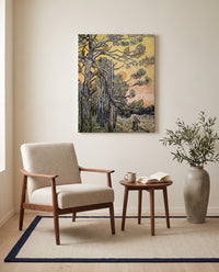 Pine Trees at Sunset by Vincent van Gogh as a stretched canvas above a linen lounge chair in a reading corner