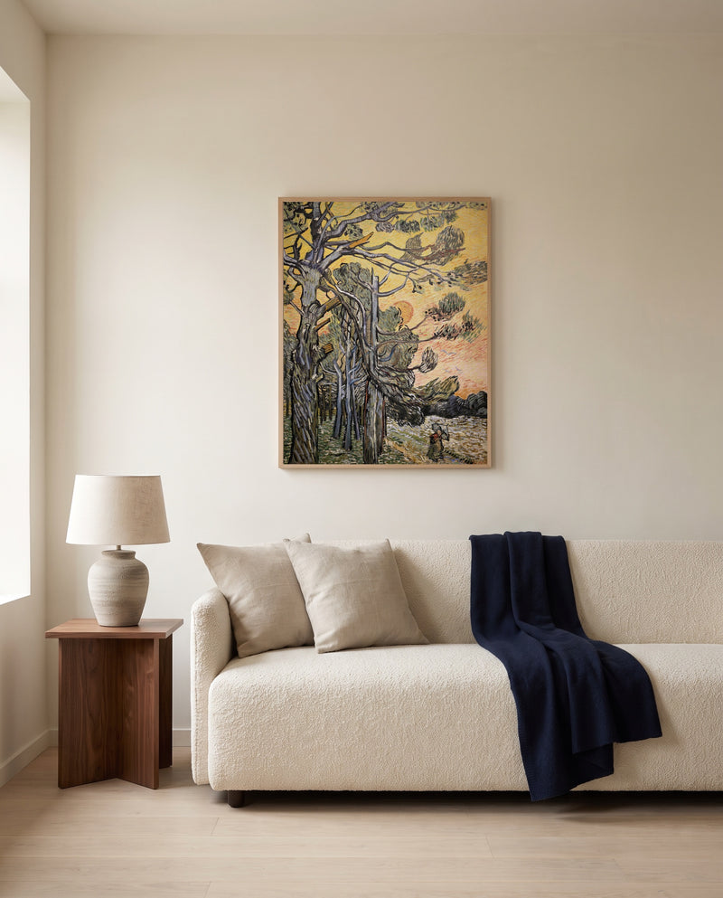 Pine Trees at Sunset by Vincent van Gogh framed in natural oak above a cream sofa in a warm living room