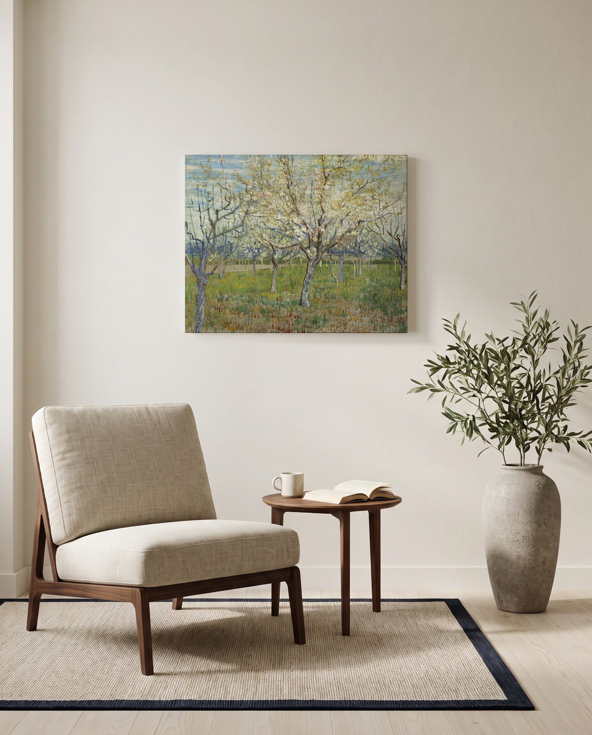 The Pink Orchard by Vincent van Gogh as a stretched canvas above a linen lounge chair in a reading corner
