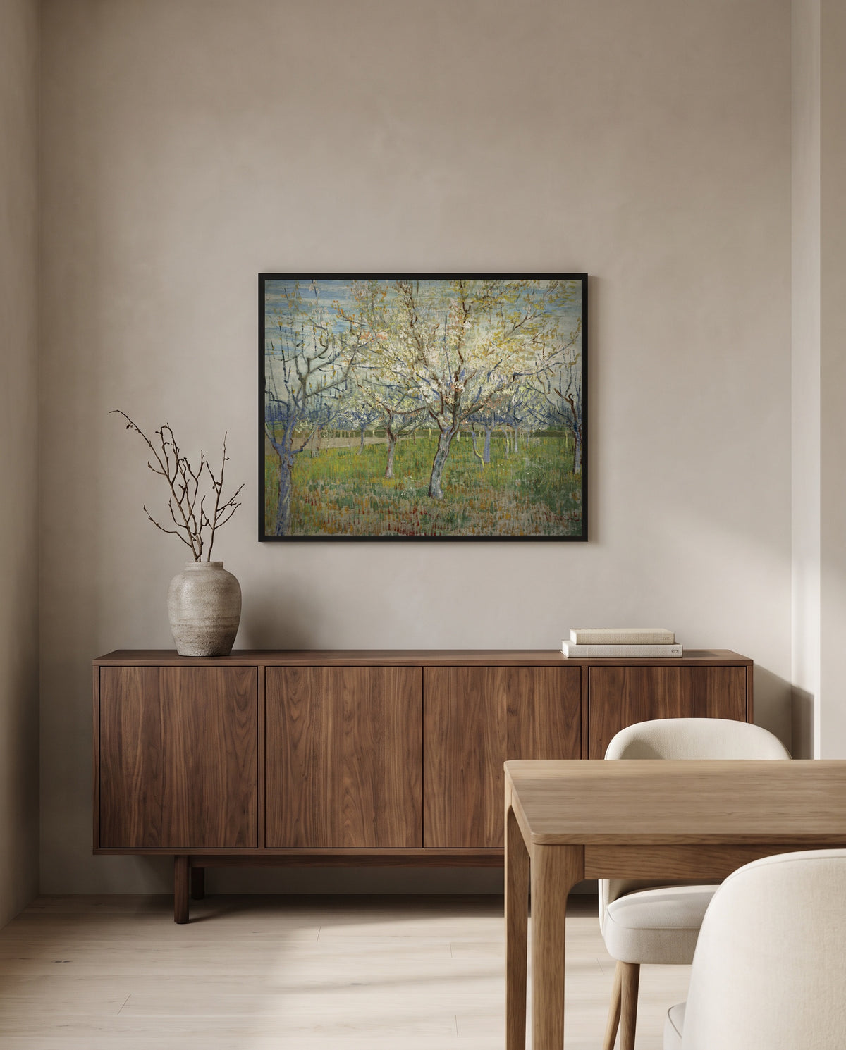 The Pink Orchard by Vincent van Gogh in a black frame above a walnut sideboard in a dining room