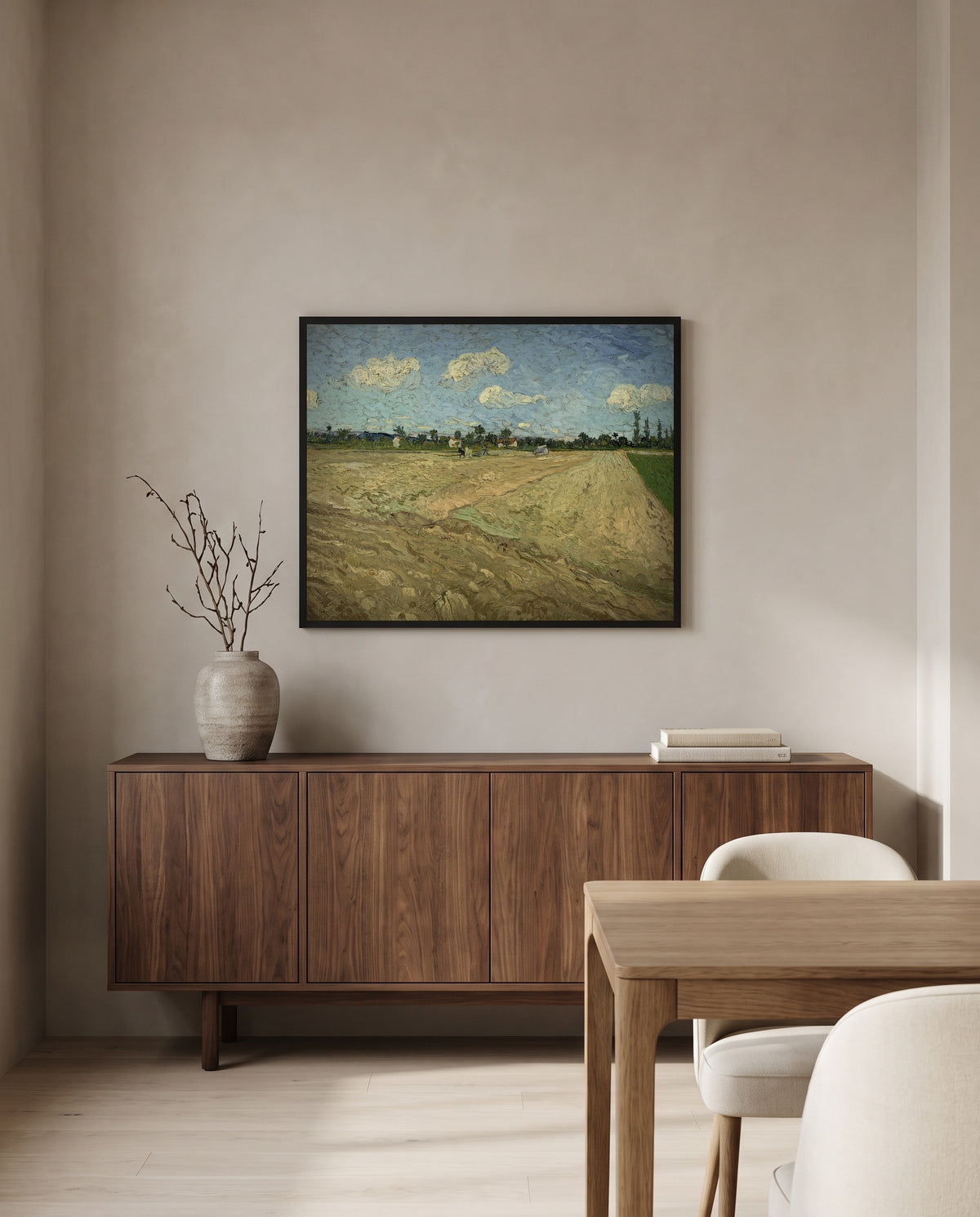 Ploughed Fields by Vincent van Gogh in a black frame above a walnut sideboard in a dining room