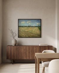 Ploughed Fields by Vincent van Gogh in a black frame above a walnut sideboard in a dining room