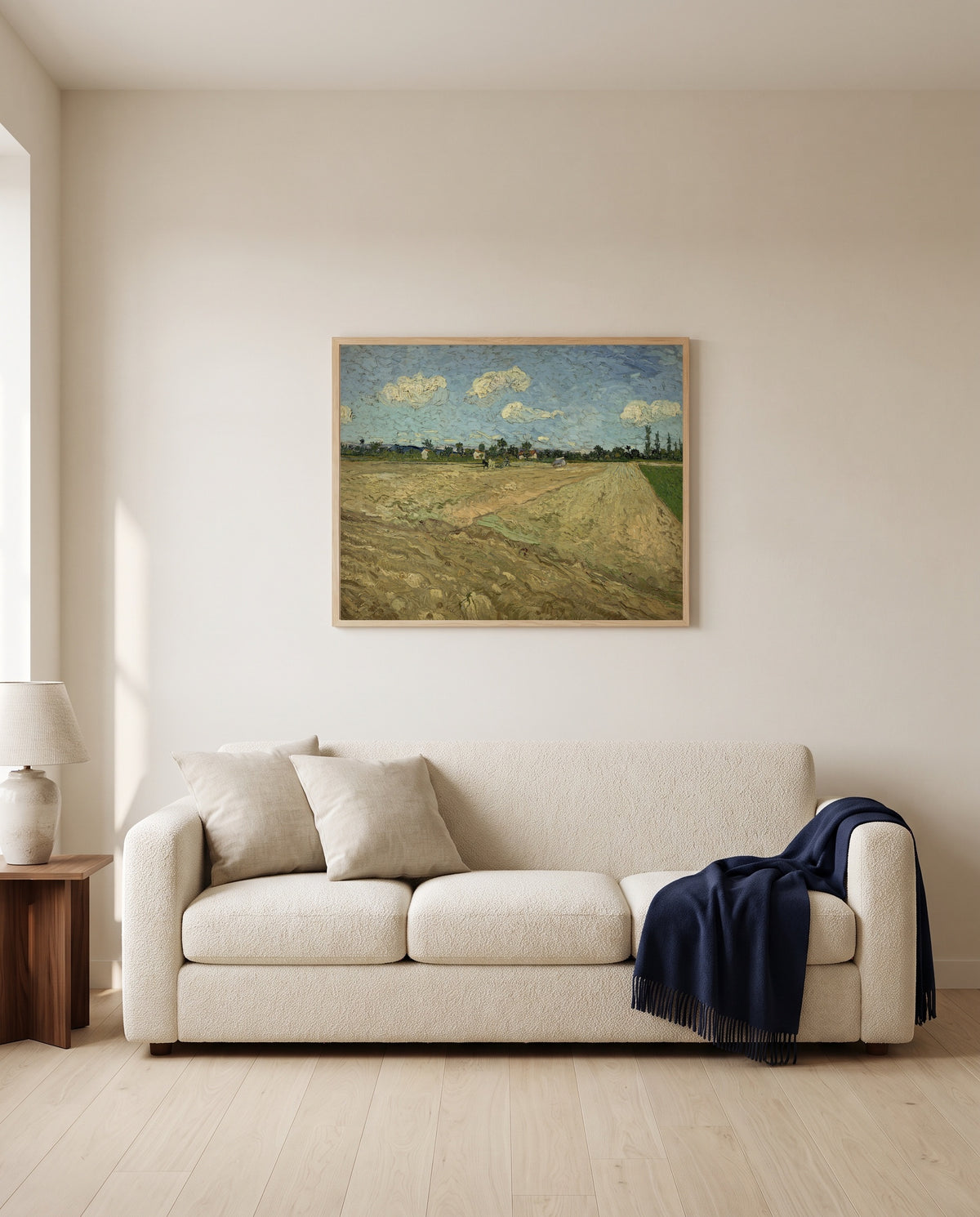 Ploughed Fields by Vincent van Gogh framed in natural oak above a cream sofa in a warm living room