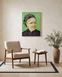 The Artist’s Mother by Vincent van Gogh as a stretched canvas above a linen lounge chair in a reading corner