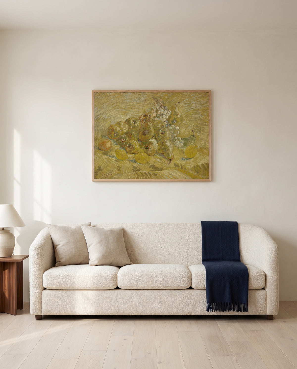 Quinces, Lemons, Pears and Grapes by Vincent van Gogh framed in natural oak above a cream sofa in a warm living room