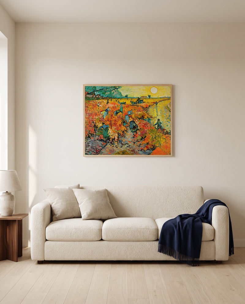 The Red Vineyard by Vincent van Gogh framed in natural oak above a cream sofa in a warm living room