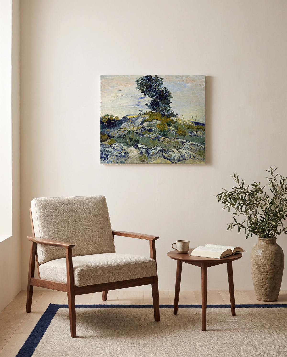 Rocks with Oak Tree by Vincent van Gogh as a stretched canvas above a linen lounge chair in a reading corner