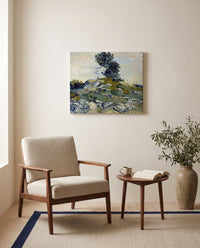 Rocks with Oak Tree by Vincent van Gogh as a stretched canvas above a linen lounge chair in a reading corner