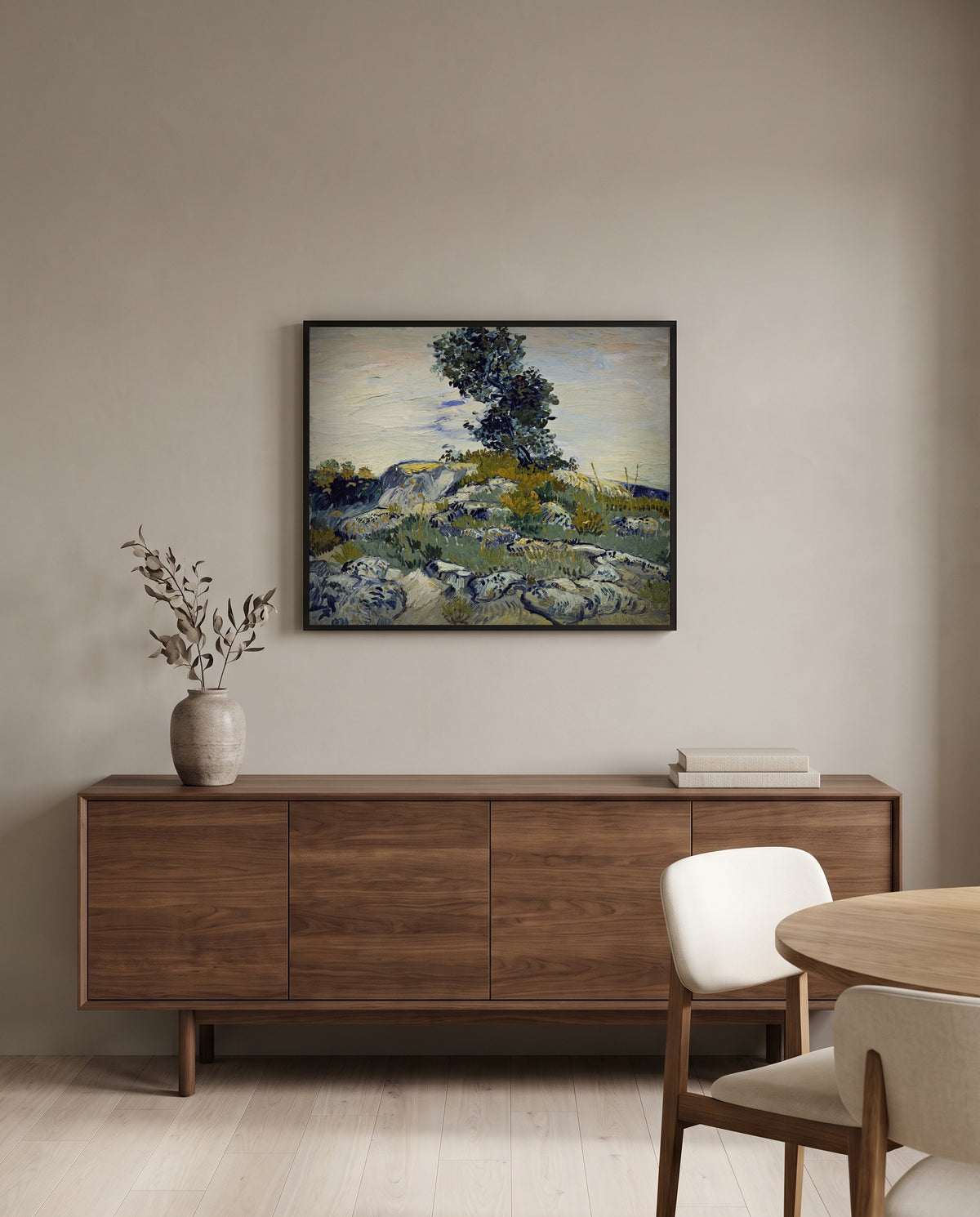 Rocks with Oak Tree by Vincent van Gogh in a black frame above a walnut sideboard in a dining room