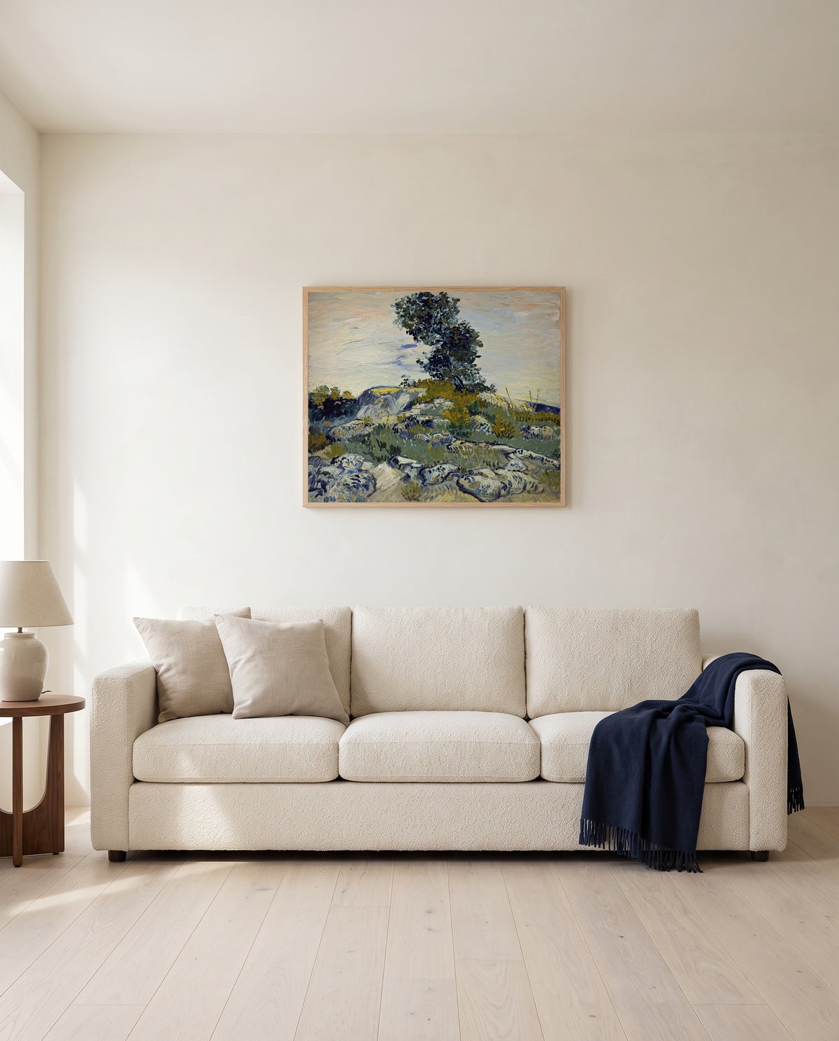 Rocks with Oak Tree by Vincent van Gogh framed in natural oak above a cream sofa in a warm living room