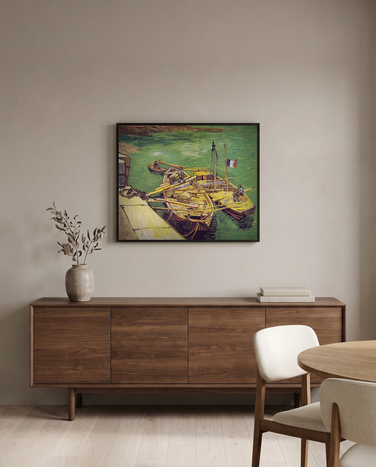 Sand Barges by Vincent van Gogh in a black frame above a walnut sideboard in a dining room