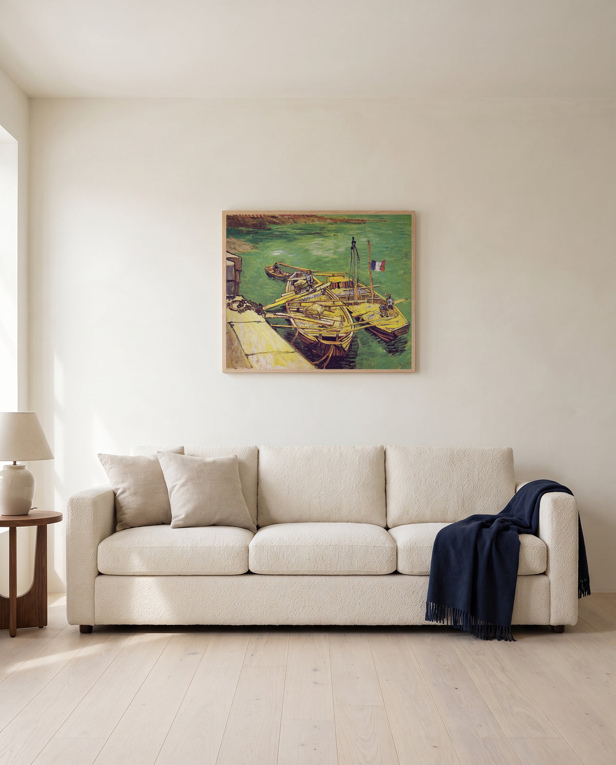Sand Barges by Vincent van Gogh framed in natural oak above a cream sofa in a warm living room