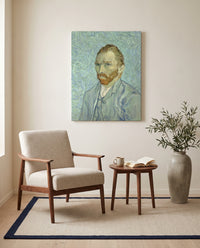 Self-Portrait, 1889 by Vincent van Gogh as a stretched canvas above a linen lounge chair in a reading corner