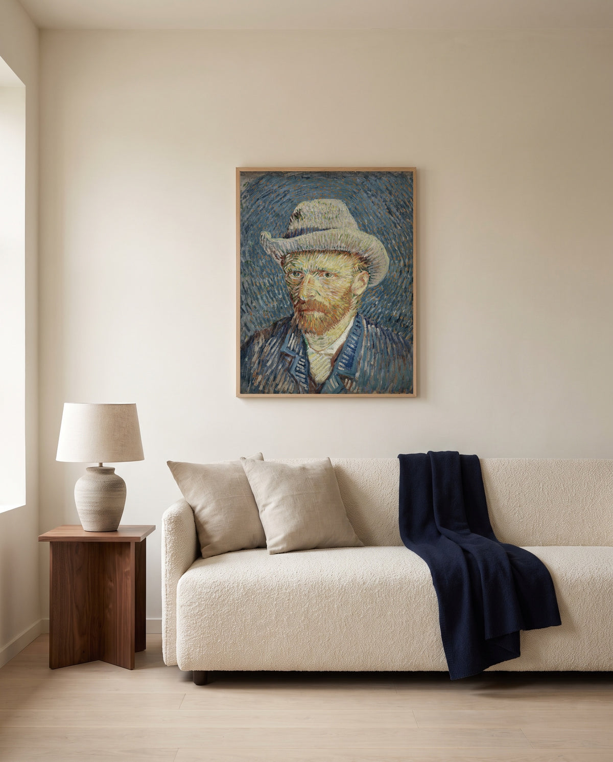 Self-Portrait with Grey Felt Hat by Vincent van Gogh framed in natural oak above a cream sofa in a warm living room