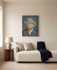 Self-Portrait with Grey Felt Hat by Vincent van Gogh framed in natural oak above a cream sofa in a warm living room