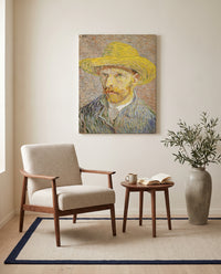 Self-Portrait with a Straw Hat by Vincent van Gogh as a stretched canvas above a linen lounge chair in a reading corner