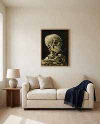 Skull with Burning Cigarette by Vincent van Gogh framed in natural oak above a cream sofa in a warm living room