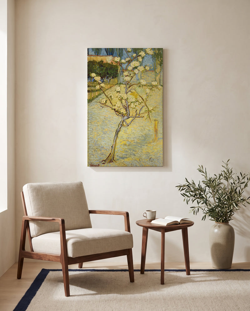 Small Pear Tree in Blossom by Vincent van Gogh as a stretched canvas above a linen lounge chair in a reading corner
