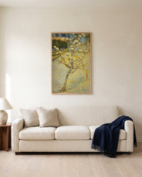 Small Pear Tree in Blossom by Vincent van Gogh framed in natural oak above a cream sofa in a warm living room