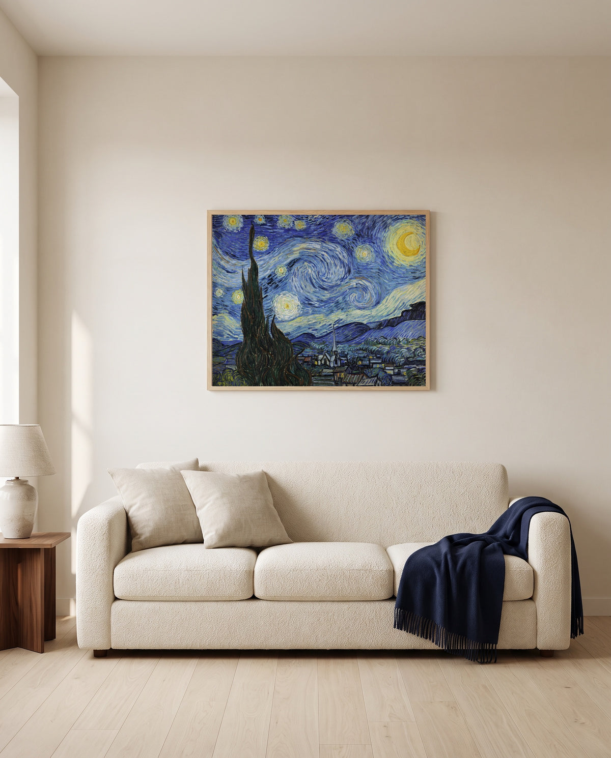 The Starry Night by Vincent van Gogh framed in natural oak above a cream sofa in a warm living room